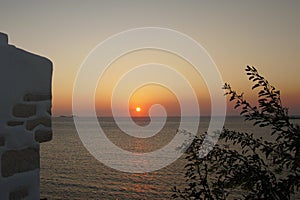 Beautiful sunset seen from the church of Agios Konstantinou, a traditional Cycladic church with blue dome in the town of Paroikia