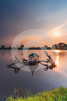 Beautiful sunset shadow in the water like a mirror, and traditional Fishing Boat with blue sky photo