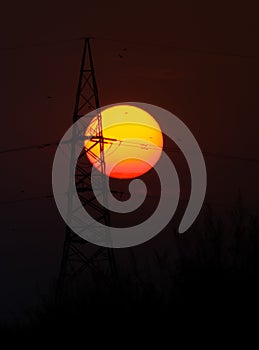 Beautiful sunset with silhouette transmission line tower.