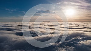 Beautiful sunset sky above clouds with dramatic light. Cabin view from airplane