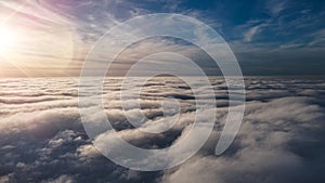 Beautiful sunset sky above clouds with dramatic light. Cabin view from airplane