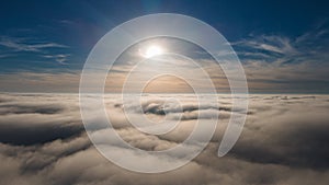 Beautiful sunset sky above clouds with dramatic light. Cabin view from airplane