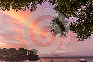 Beautiful sunset with sky over calm sea in tropical Bali island, Indonesia.