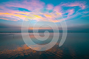 Beautiful sunset sky over the sea in the evening. Blue sky and purple, orange, and yellow clouds. Dramatic sky and clouds