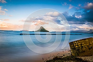 Beautiful sunset sky over the water with stone formations in Oahu Island, Hawaii