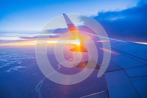 Beautiful sunset, sky on the top view, airplane flying view from inside window aircraft.
