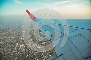 Beautiful sunset, sky on the top view city, airplane flying view from inside window aircraft.