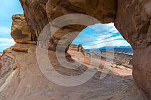 Beautiful sunset sky with view Delicate Arch through Window