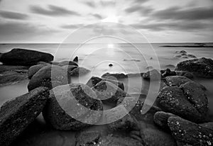 Beautiful sunset at the stone beach in black and white