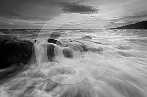 Beautiful sunset at the stone beach in black and white