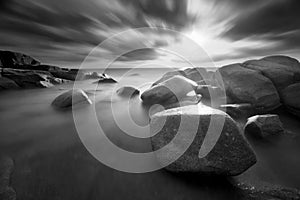 Beautiful sunset at the stone beach in black and white