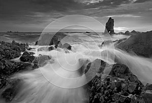 Beautiful sunset at the stone beach in black and white