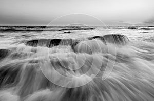 Beautiful sunset at the stone beach in black and white