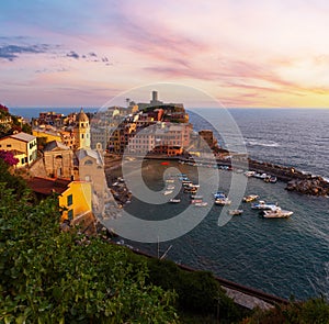 Beautiful sunset in summer Vernazza - one of five famous villages of Cinque Terre National Park in Liguria, Italy, suspended