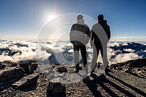 Hikers on the summit of Mt. Kita at sunset, tallest mountain in the Japanese Southern Alps