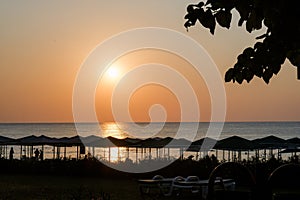 Beautiful sunset sunrise beach with pink sky and pier. Travel, relax and meditation concept