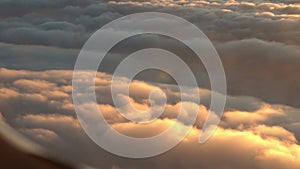 Beautiful sunset, sunrise, cloudscape and sun through airplane window