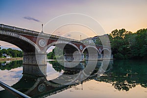 Beautiful sunset view of the arch bridge over the river Po in the city of Turin, Italy