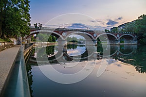 Beautiful sunset view of the arch bridge over the river Po in the city of Turin, Italy