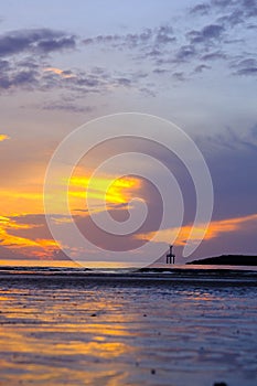 Beautiful sunset view on the beach. Colorful sea beach sunset with golden light reflected on the water surface and soft waves.