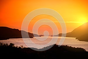 Beautiful sunset view of Connemara region in Ireland. Scenic Irish countryside landscape with magnificent mountains on the horizon