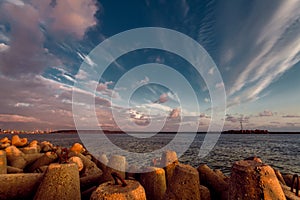 Beautiful sunset view of the port aquatory and boulders for strengthening. Klaipeda, Lithuania photo