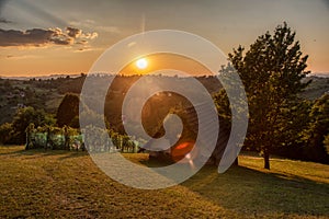 Beautiful sunset in the vineyard of the village with a wooden house