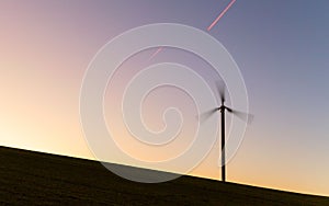 Beautiful sunset with a winmill in movement photo
