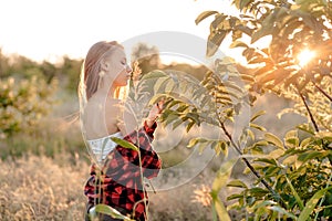 Beautiful sunset and woman enjoy nature talking with a tree