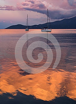 Beautiful sunset and yacht in the Ionian Sea on the island of Kefalonia in Greece