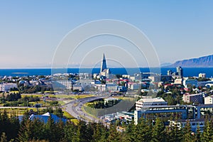 Beautiful super wide-angle aerial view of Reykjavik, Iceland with harbor and skyline mountains and scenery beyond the city, seen f