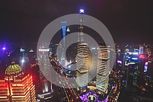 Beautiful super wide-angle night aerial view of Shanghai, China with Pudong district, TV tower, the Bund and scenery beyond the ci