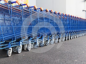 Beautiful supermarket carts piled up in line waiting to be caught to transport goods photo