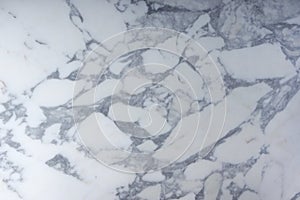 The beautiful surface of natural stone, light marble with a gray pattern, is called Arabescato