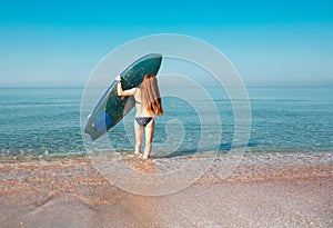 Beautiful surfer girl on the beach