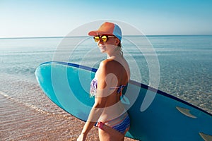 Beautiful surfer girl on the beach