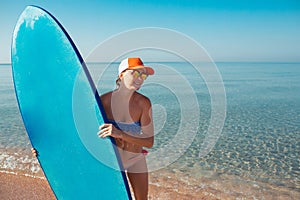 Beautiful surfer girl on the beach