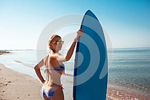 Beautiful surfer girl on the beach