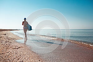 Beautiful surfer girl on the beach