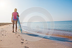 Beautiful surfer girl on the beach