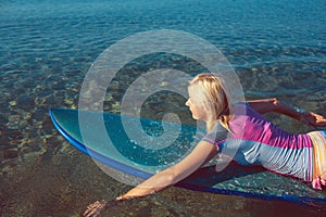 Beautiful surfer girl on the beach