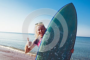 Beautiful surfer girl on the beach