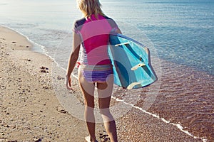 Beautiful surfer girl on the beach