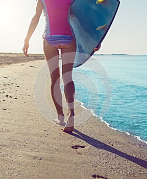 Beautiful surfer girl on the beach