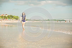 Beautiful surfer girl on the beach at sunset