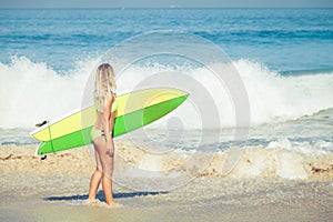 Beautiful Surfer Girl walking on the Beach