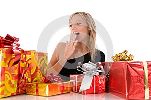 Beautiful surprise girl looks colorful gifts
