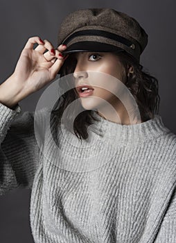 Beautiful surprised brunette girl wearing a casual style knitted