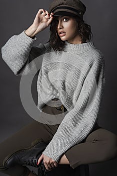 Beautiful surprised brunette girl wearing casual style sweater,