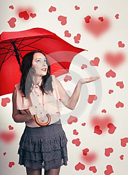 Beautiful surprised valentine's girl with umbrella in love.